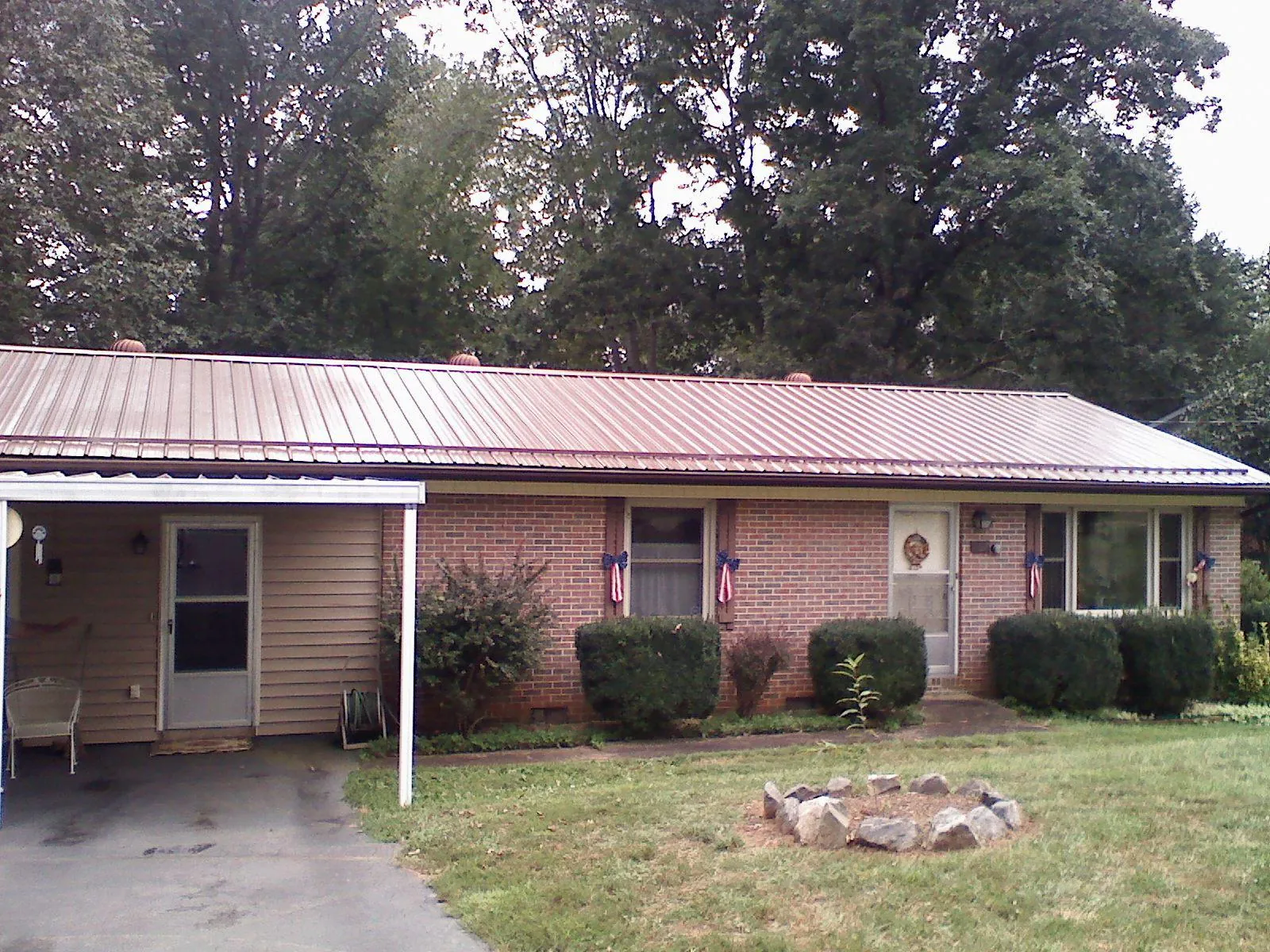 Bronze metal roof and carport on a brick ranch home — Roof Repair work by our crew in Mascoutah