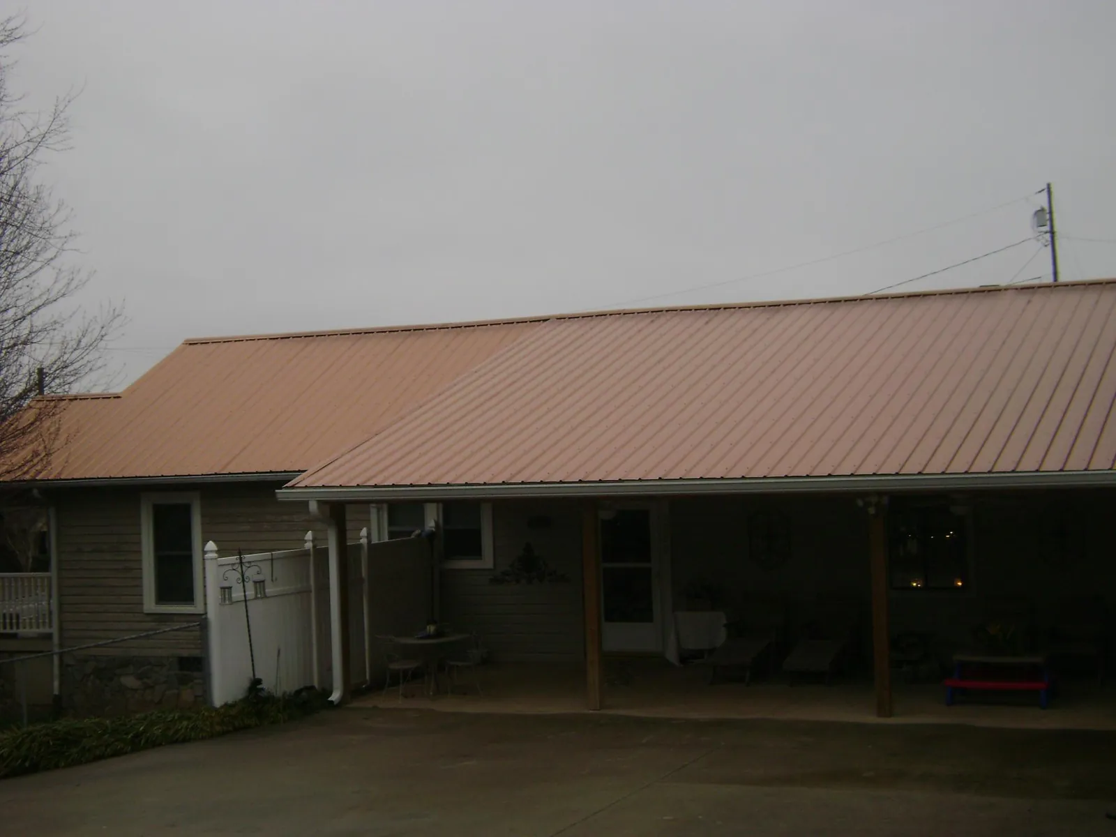 Copper toned metal roof over a wide covered patio in Mascoutah
